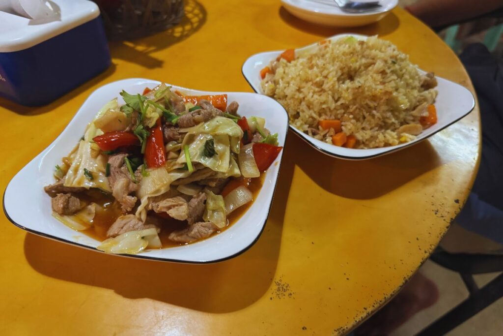 fried rice dish with a pork and vegetable meal