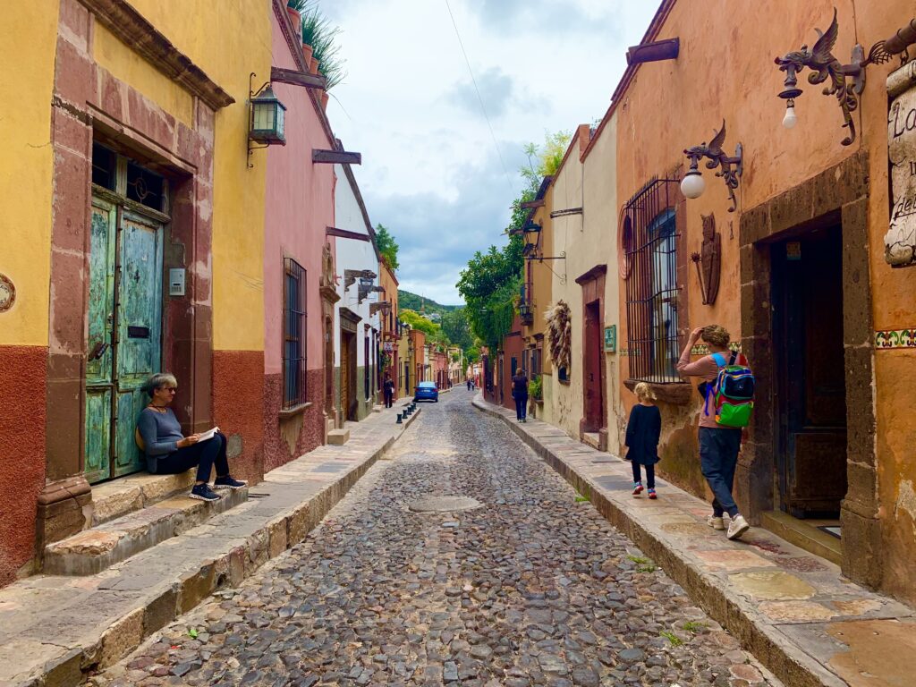 cobblestone streets with colorful buildings lining a street