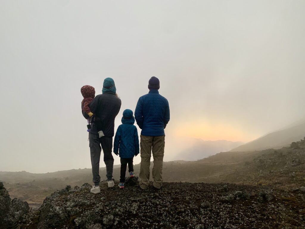4 people looking out at a sunrise