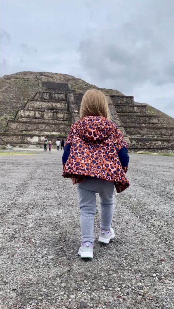girl walking up to a large pyramid