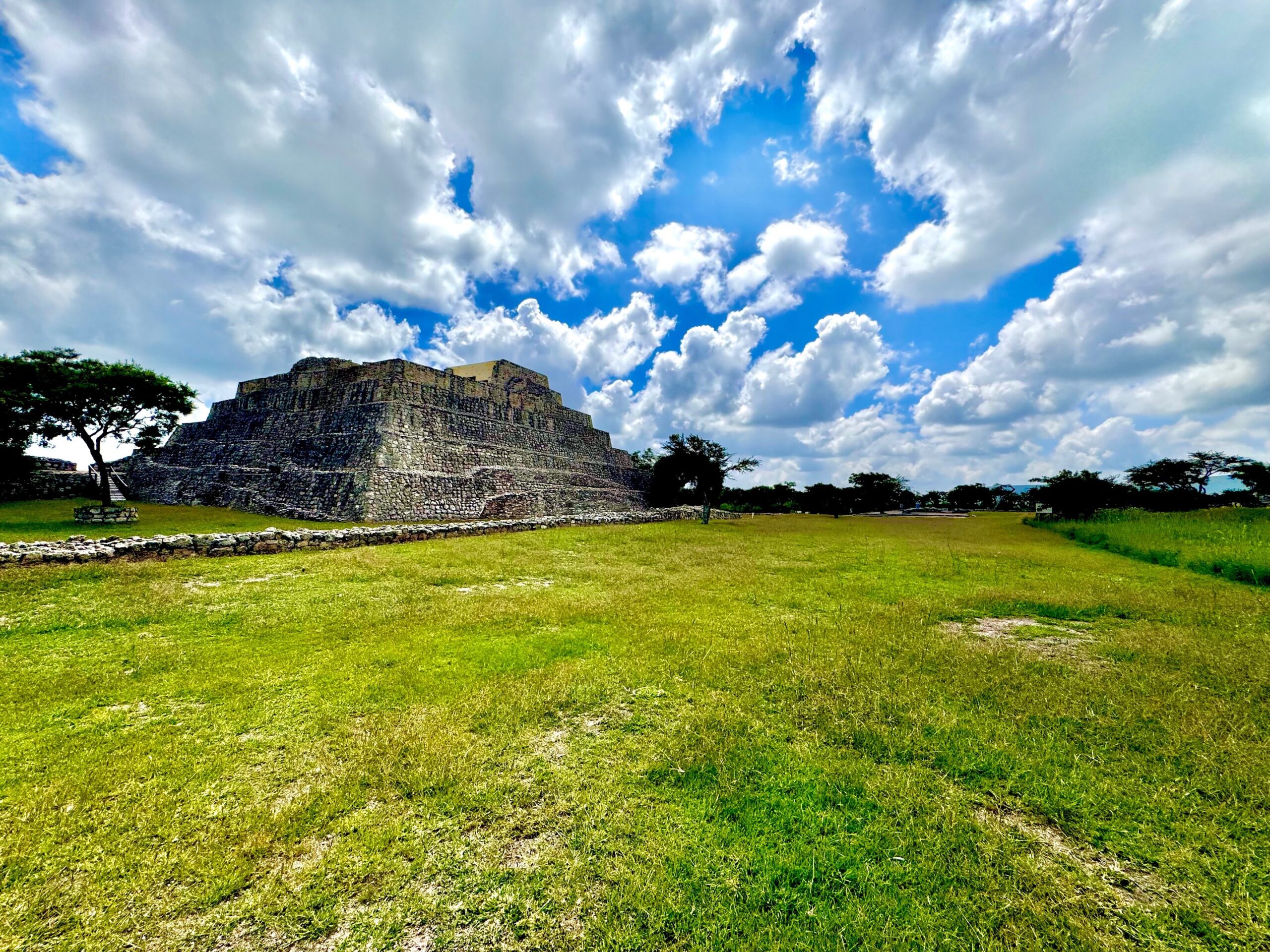 Pyramids with beautiful sky and green grass foreground