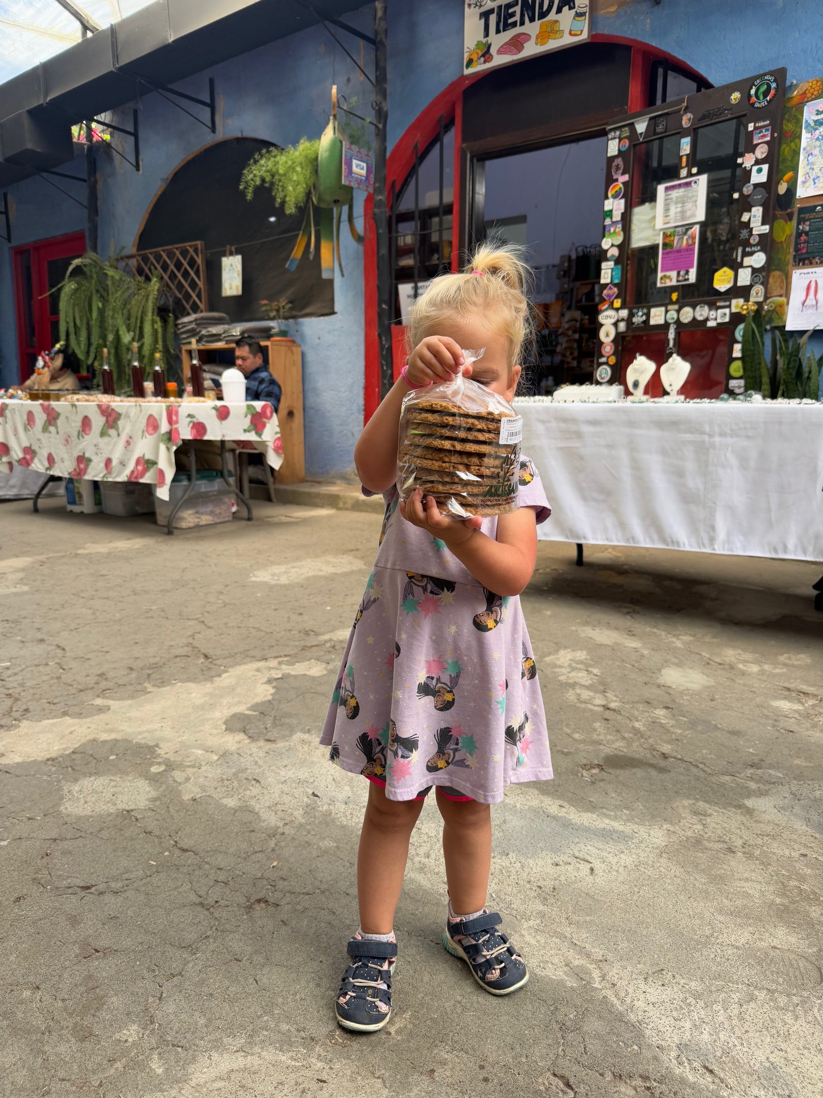 child holding up goods at a market