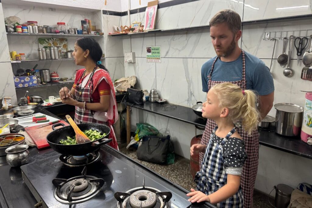girl with 2 adults in a kitchen for a cooking class
