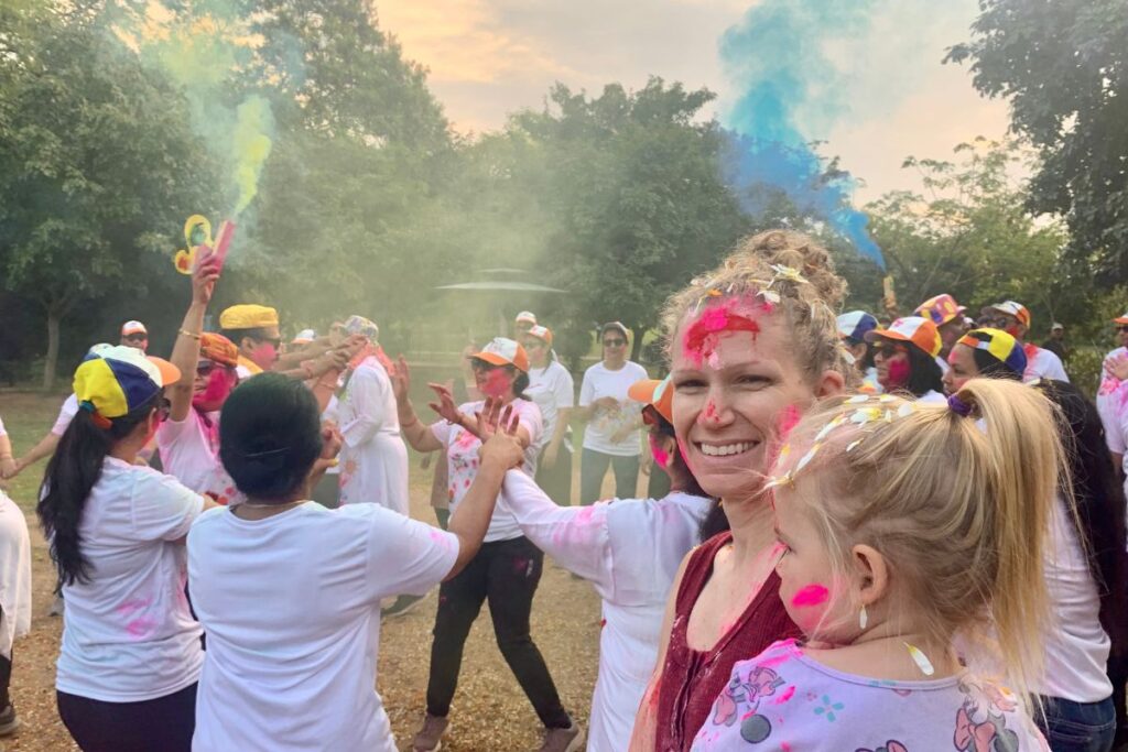 people celebrating by throwing colors in the air