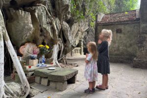 two children at a temple altar