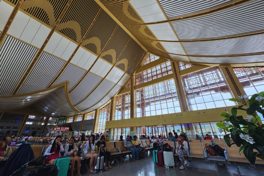 people sitting in a large train station terminal