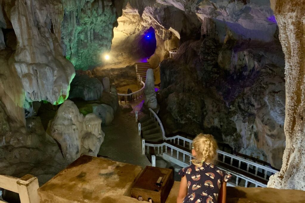 girl in a cave lit up by lights
