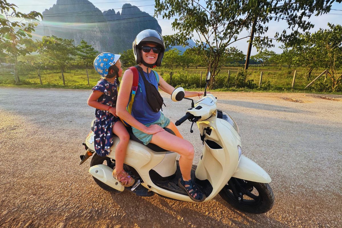 woman and a child on a motorbike