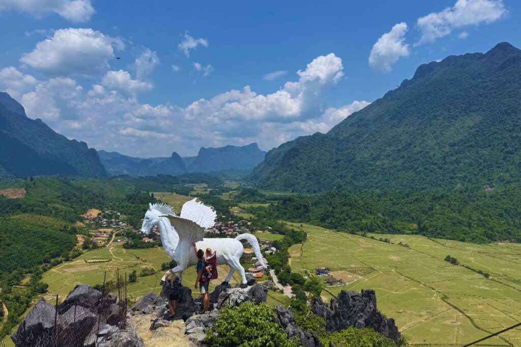 people on top of a viewpoint with a white pegasus statue