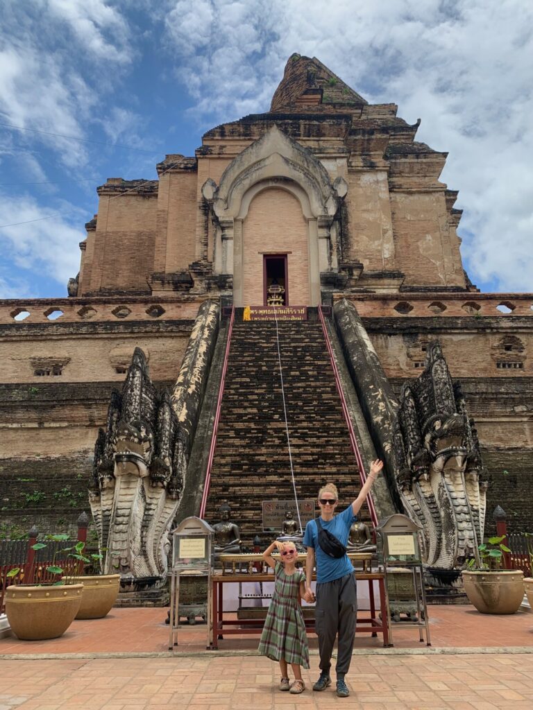 woman and a girl standing in front of Wat Chedi Luang