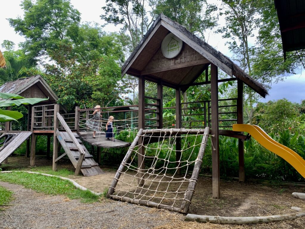 two girls running across a bridge on a playground