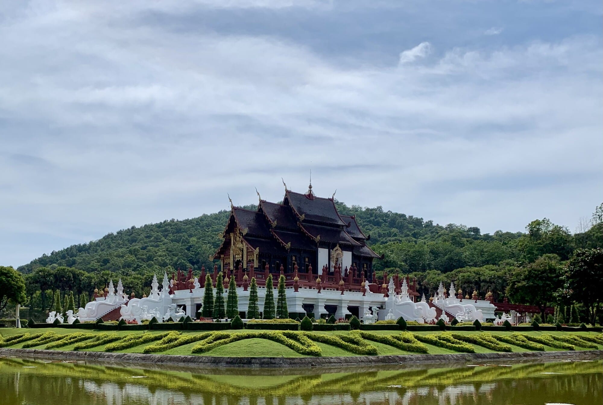 a palace that is reflected in water with a blue sky