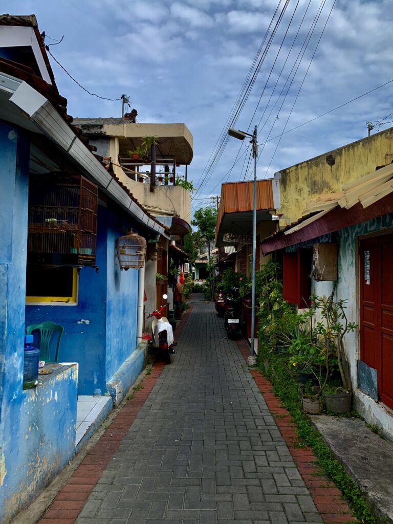 walkway with colorful buildings and a scooter