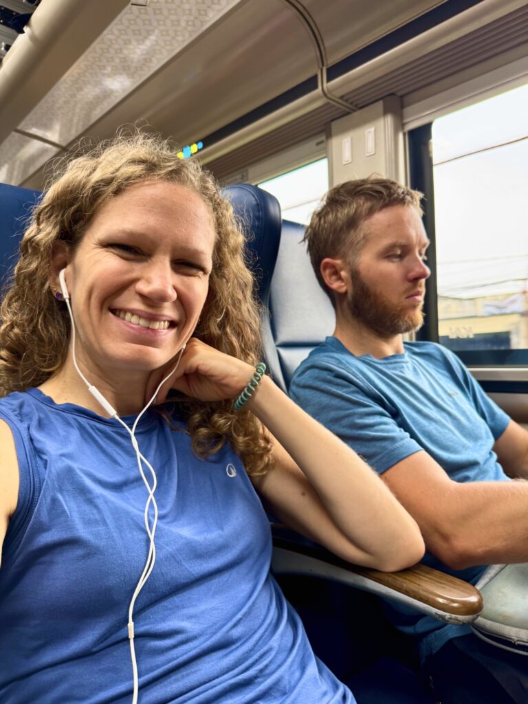 two people sitting on a train
