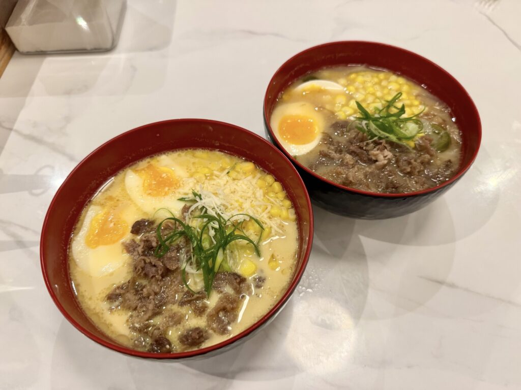 two bowled meals with corn, beef, soft boiled eggs and broth