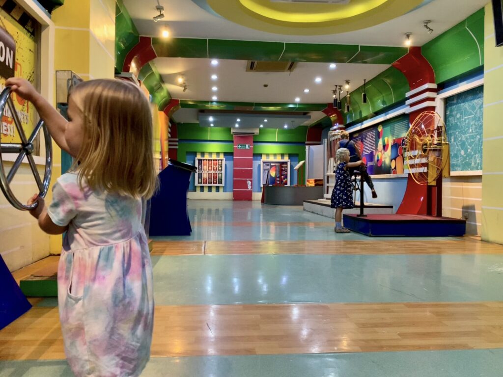 girl playing in a science museum