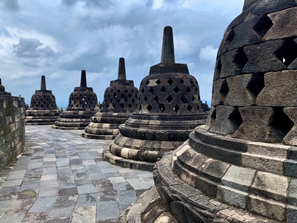 bell shaped stupas on top of a temple