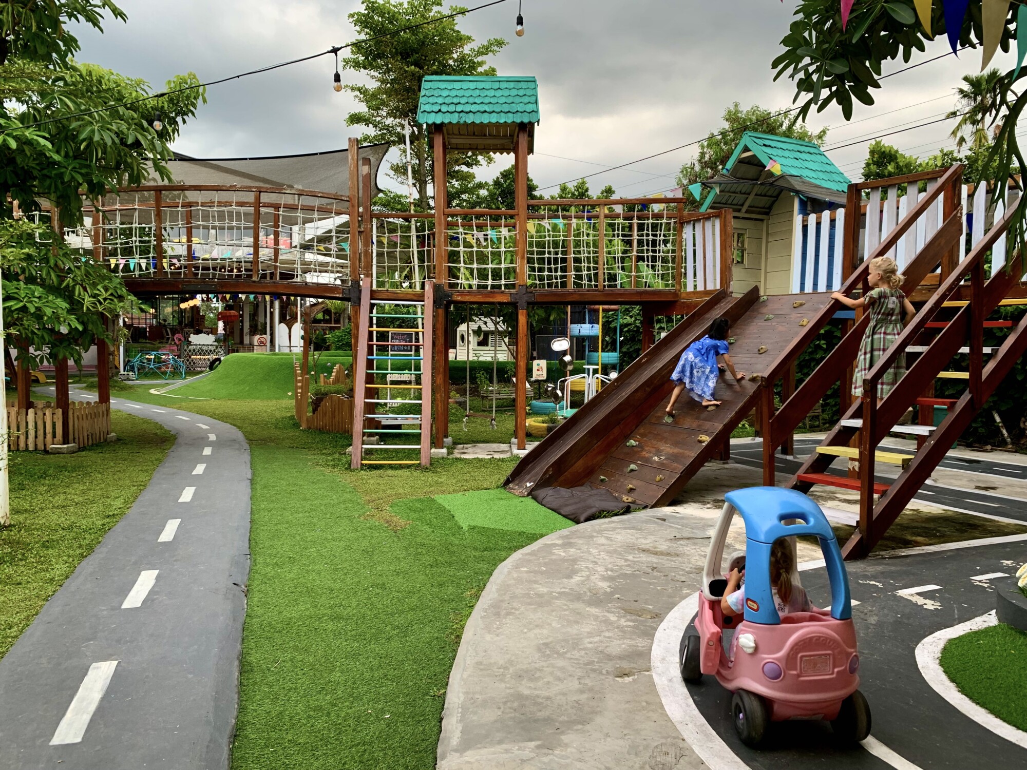 children playing at an outdoor playground with bright colors