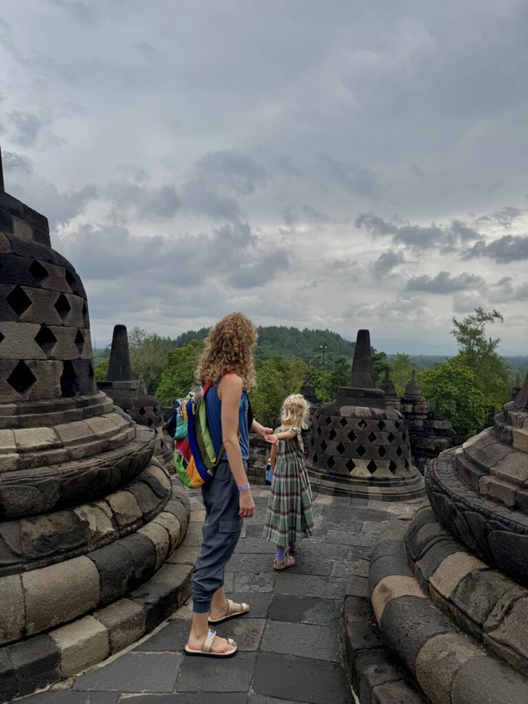 mom and a girl taking pictures at a temple