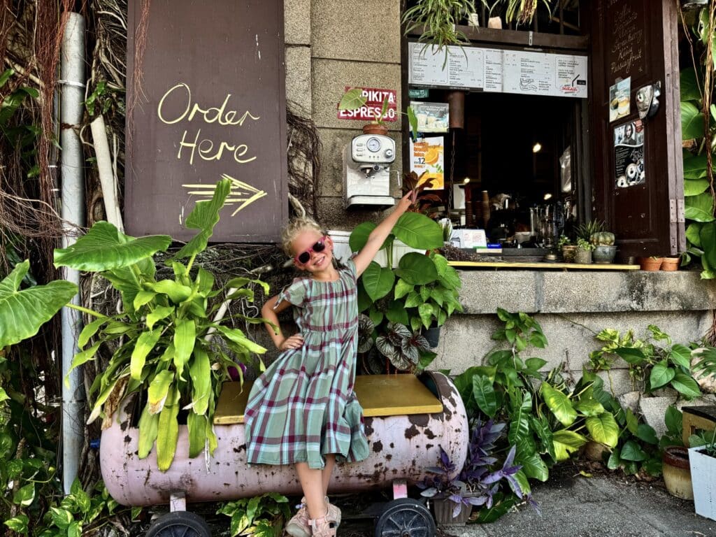 a girl pointing to an order here window