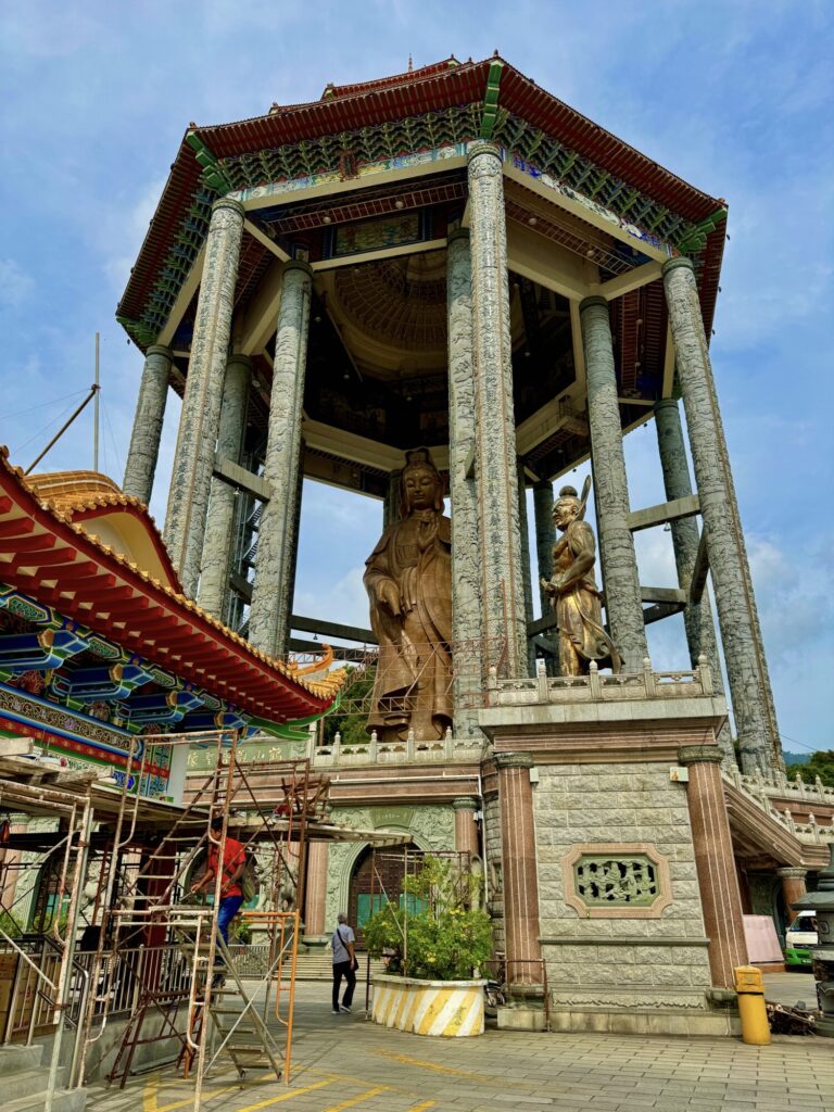 large statue under a pagoda