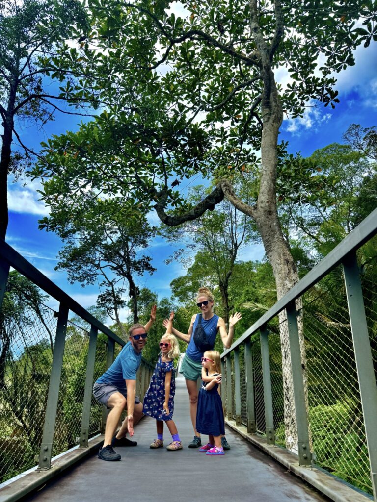 a family of four with 2 young kids doing a silly pose