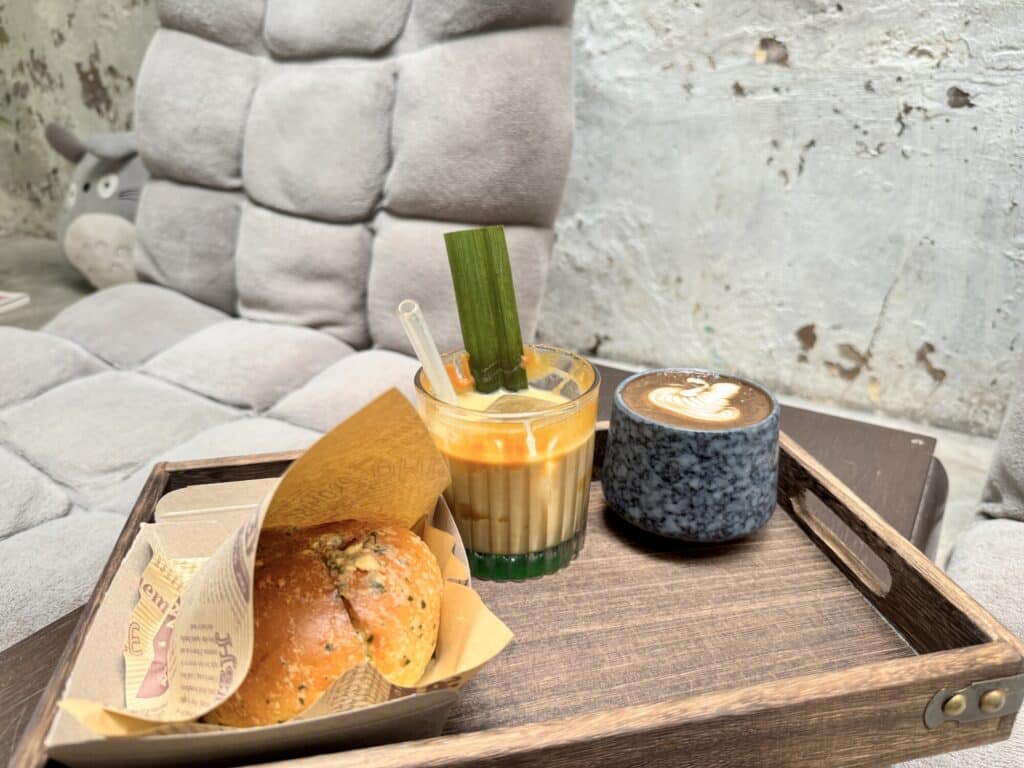 a bagel and two different coffees beautifully presented