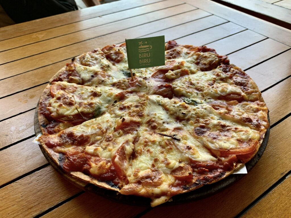 pizza on a brown table with a flag in the middle