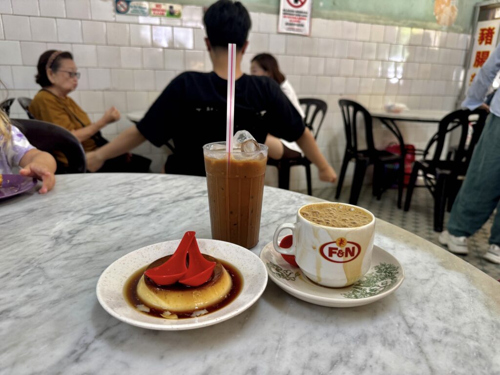 hot white coffee, iced coffee, and dessert on a table