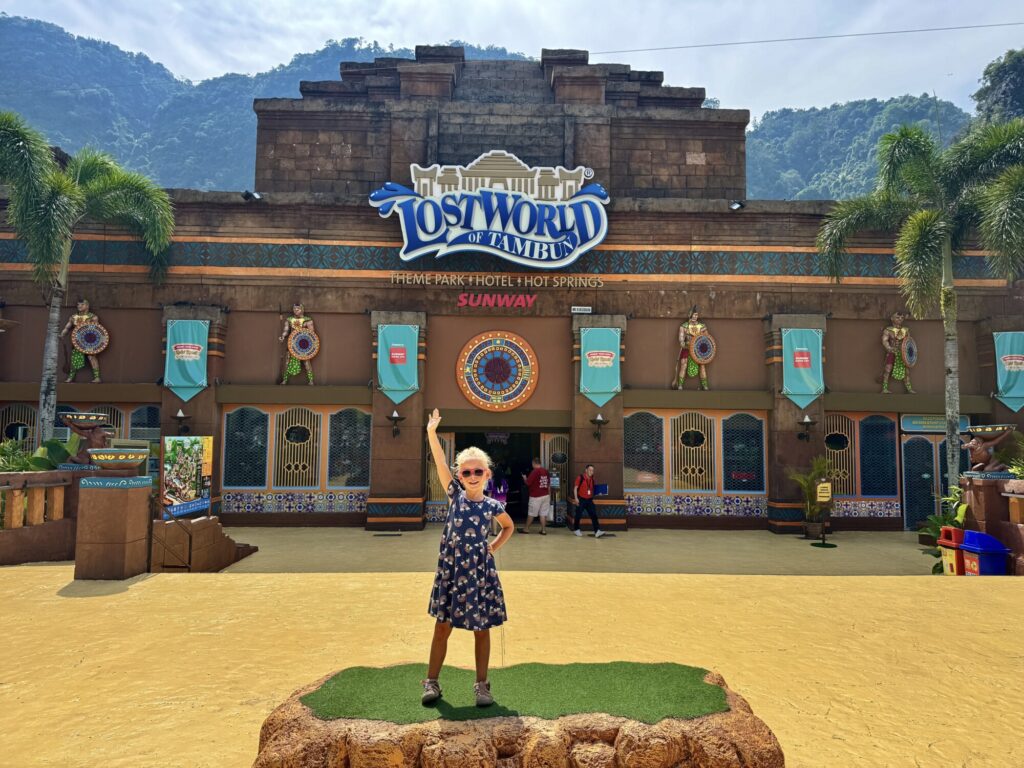 girl posing at an entrance to a theme park