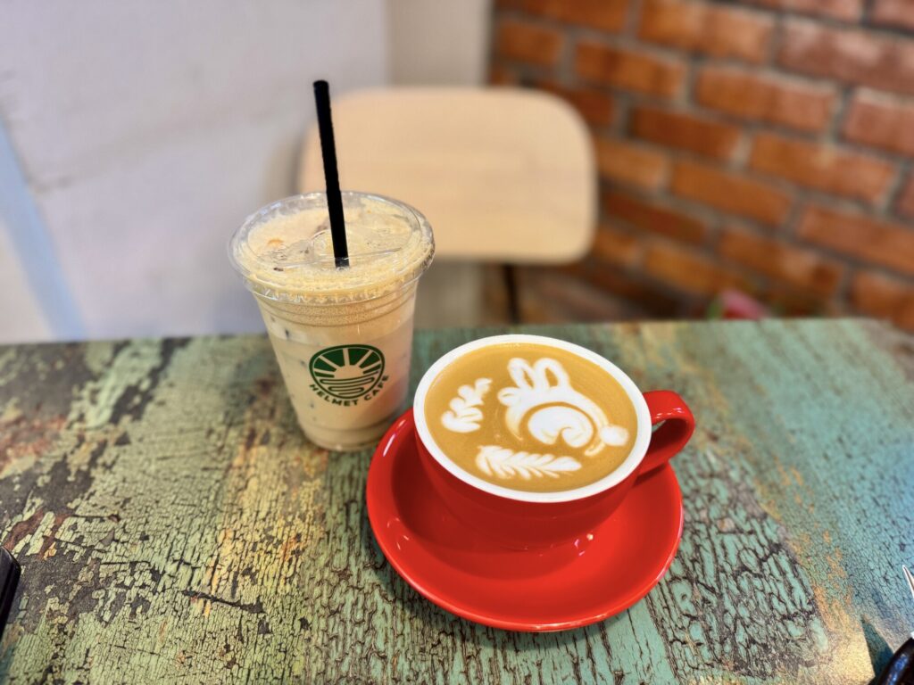 iced coffee and a latte in the shape of a bunny on a table