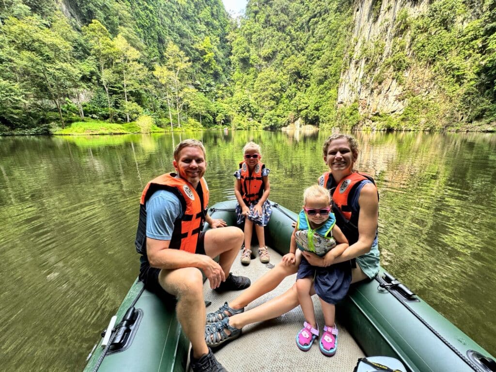 family with two young kids on a raft on a lake