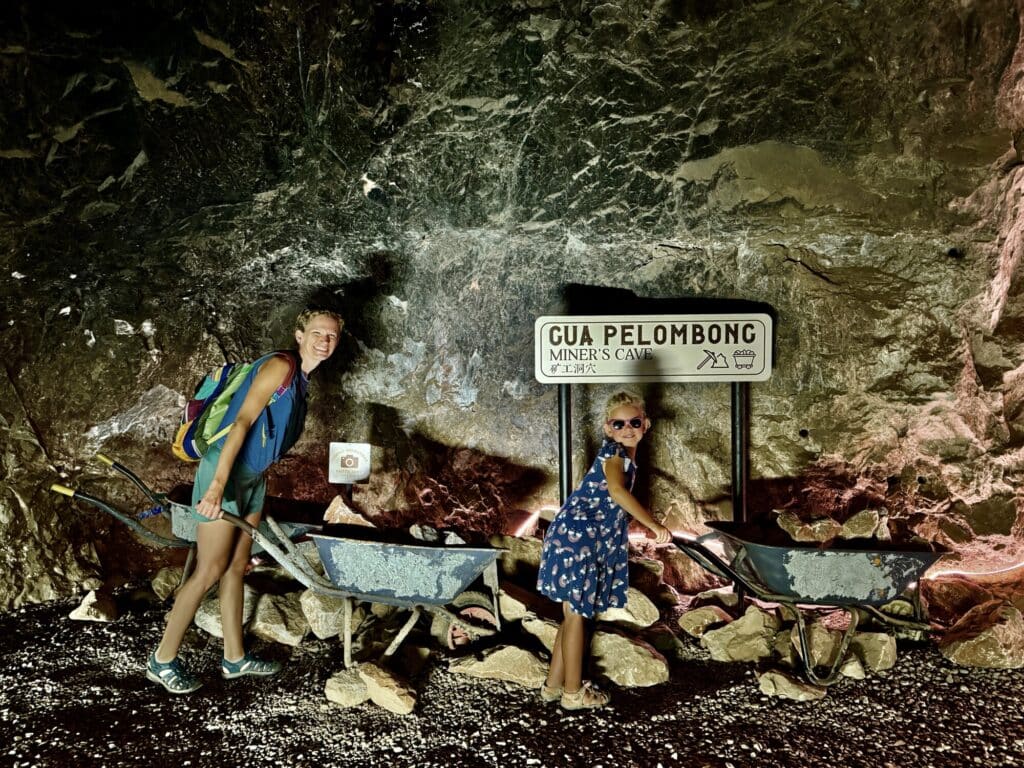 a mom and a daughter acting like miners in a tunnel