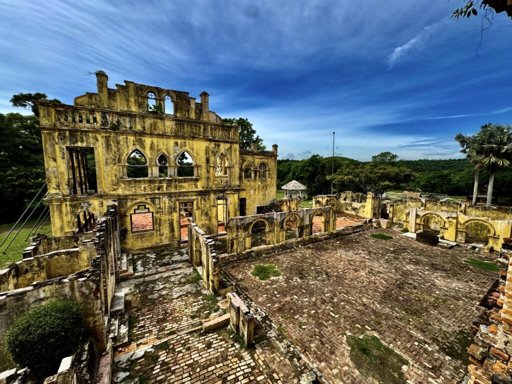 unfinished ruins with brick ground of a castle with yellow paint