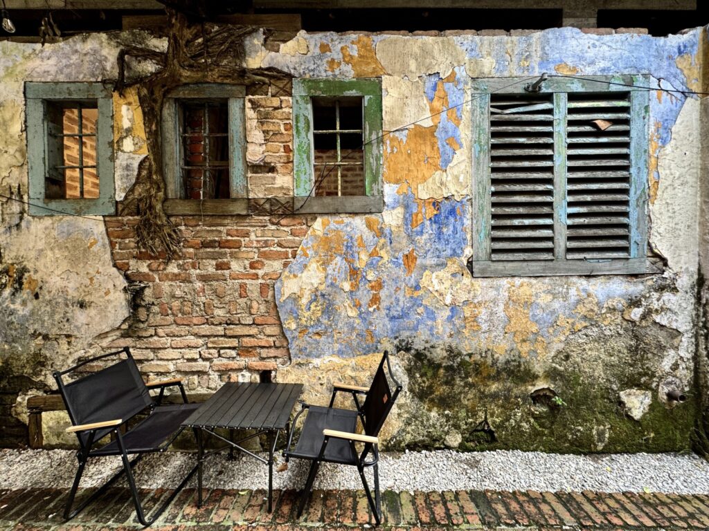 beautifully decorated rustic wall with a small table and chairs