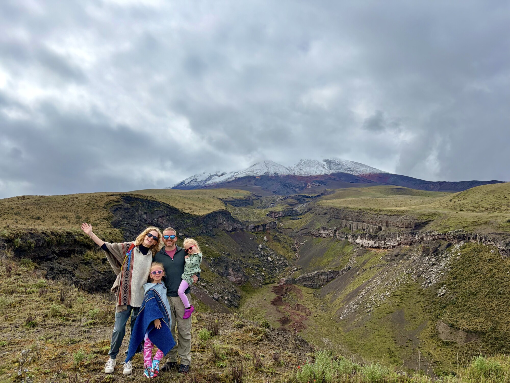 family standing in front of a volcano