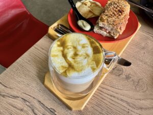 a latte with a face imprinted on the foam