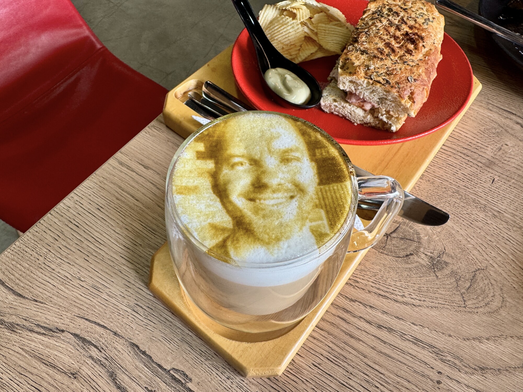 a latte with a face imprinted on the foam