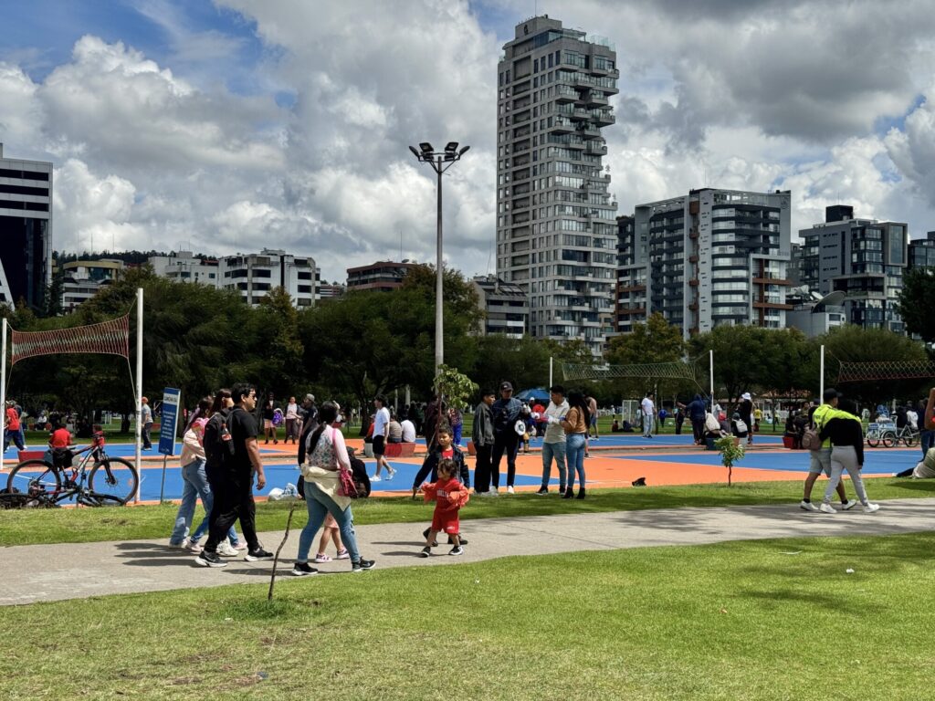 a park that is busy with lots of people performing activities