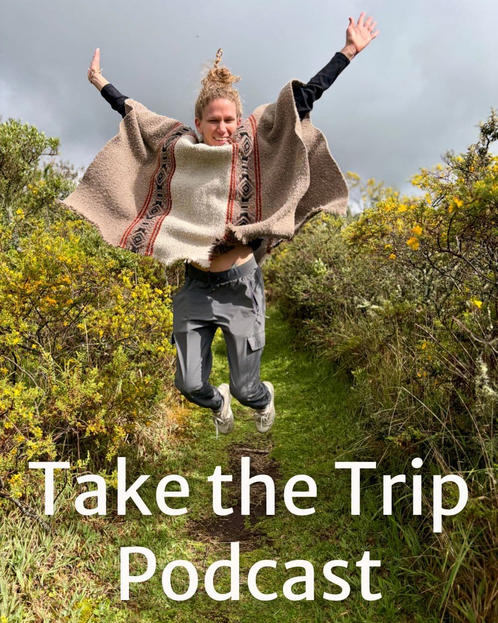 woman jumping for joy while wearing a poncho