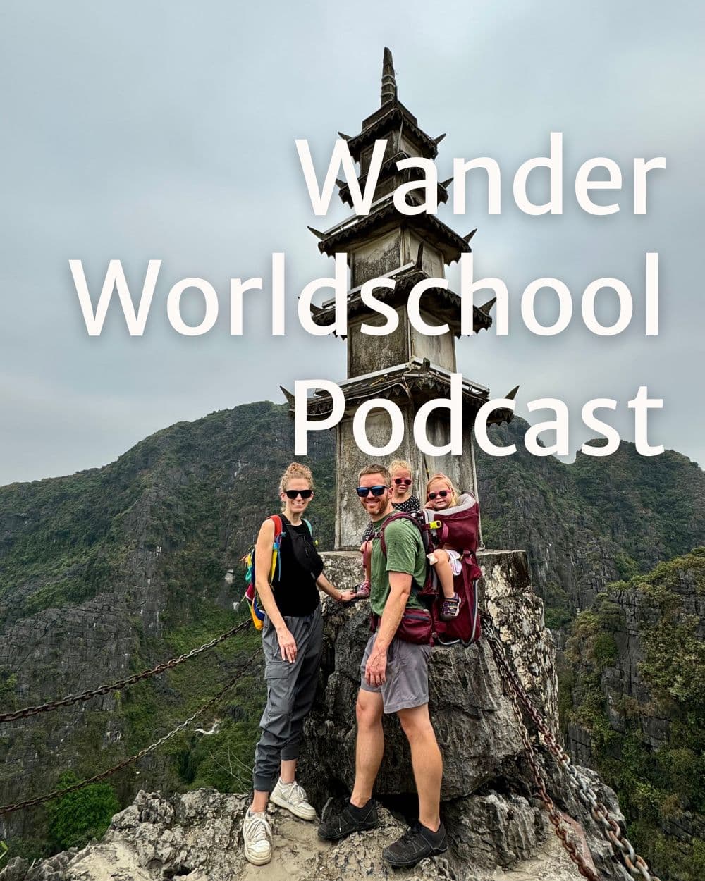 family posing in front of a pagoda on a hilltop