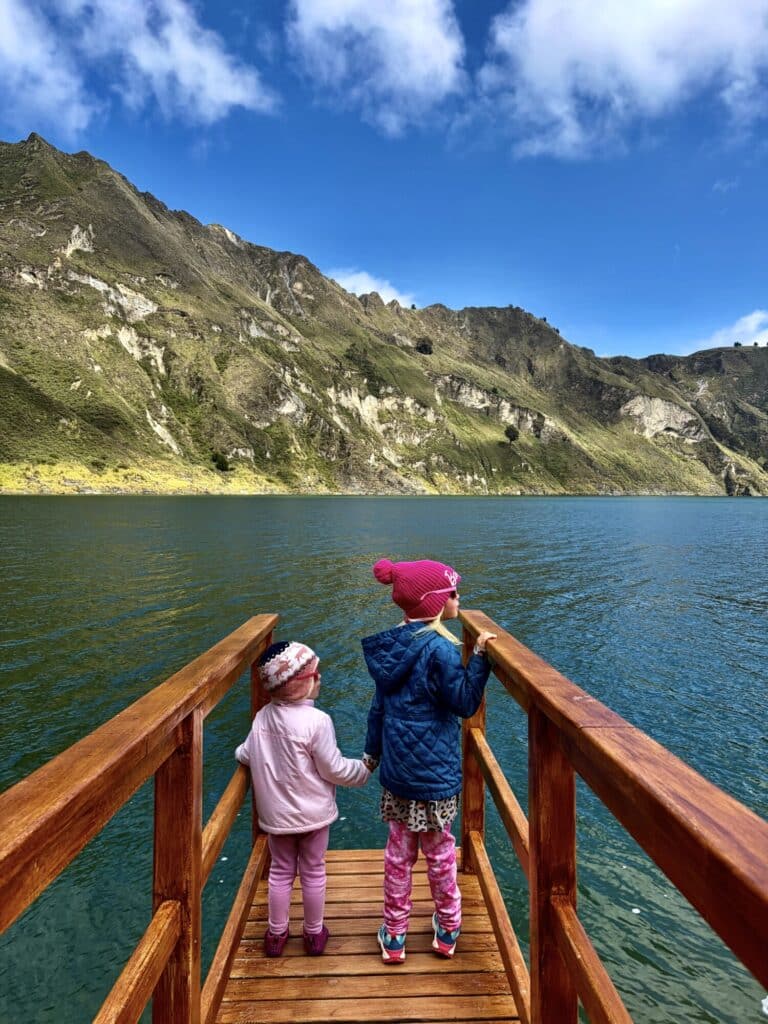 two girls at a dock at a crater lake