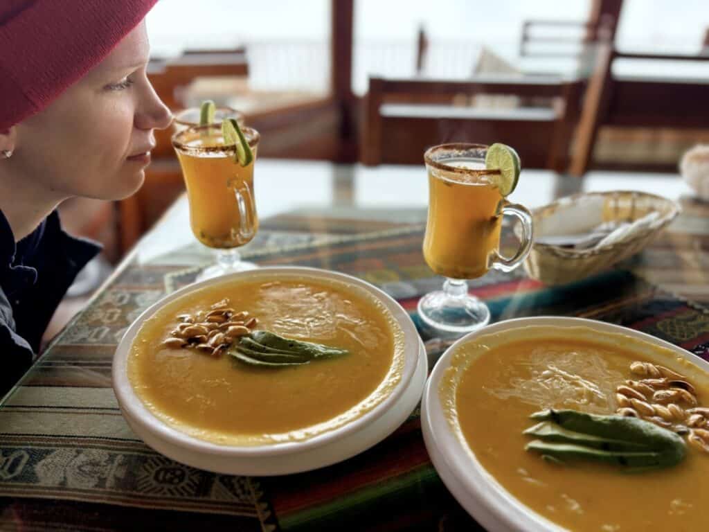 two soup dishes and drinks at a restaurant