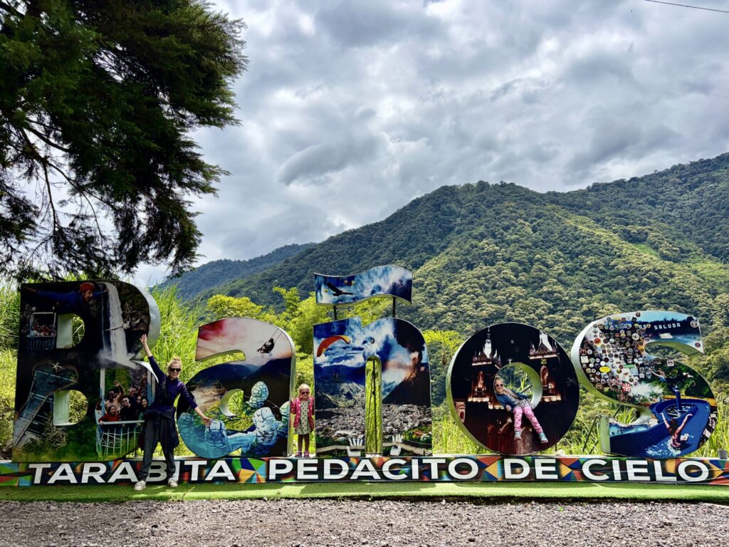 a city sign with a family posing in it