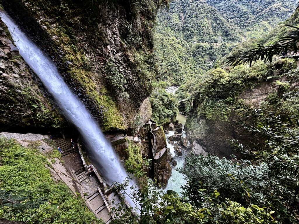 large waterfall with water flowing off into the distance through a canyon