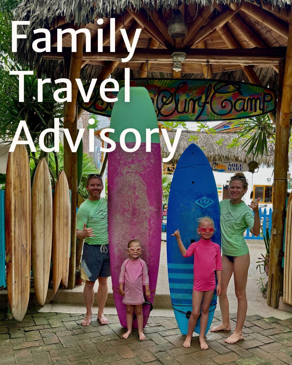 family standing next to colorful surf boards