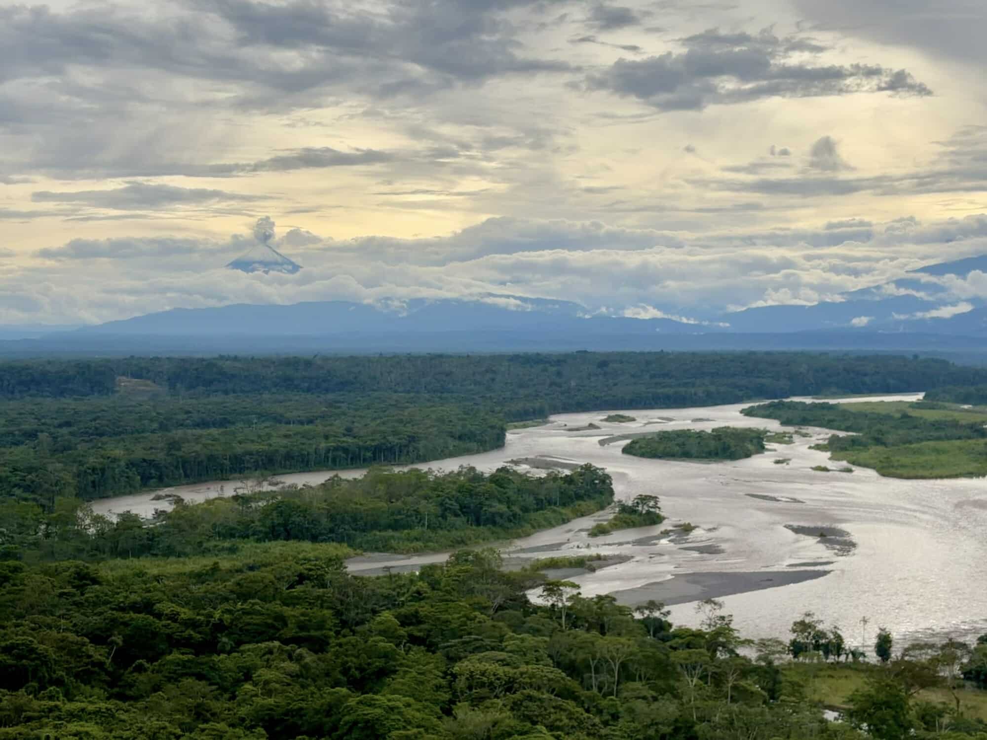 overlooking the Amazon Rainforest with a volcano in the distance