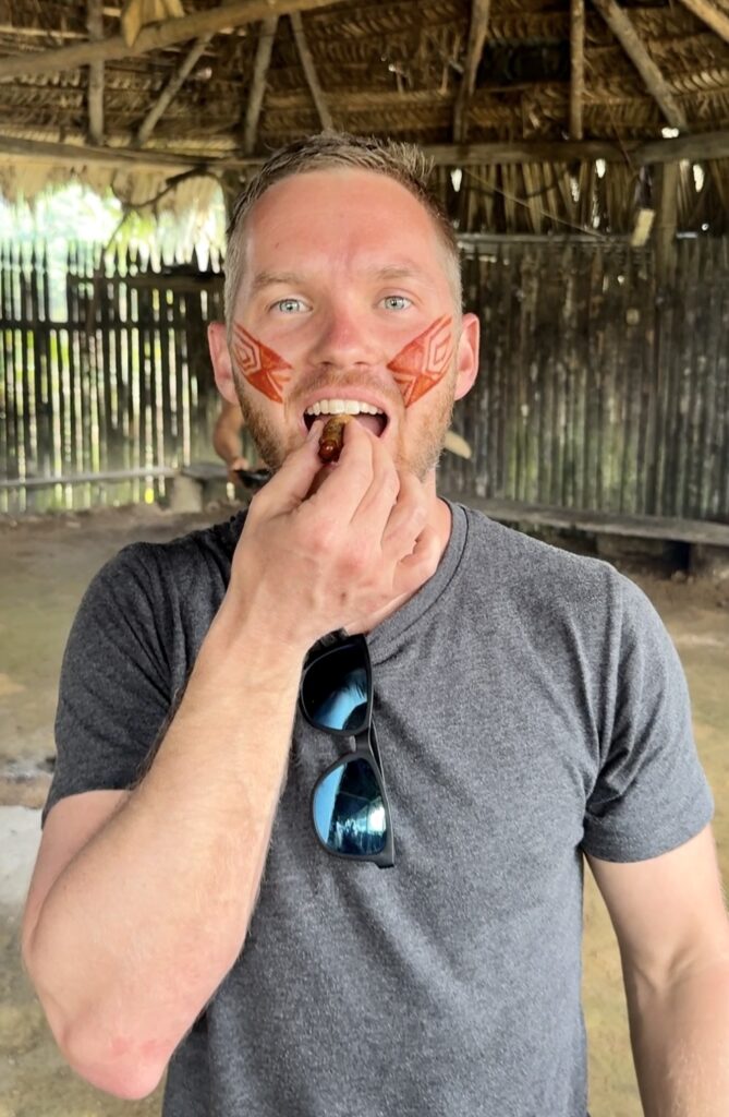 a man eating a grub