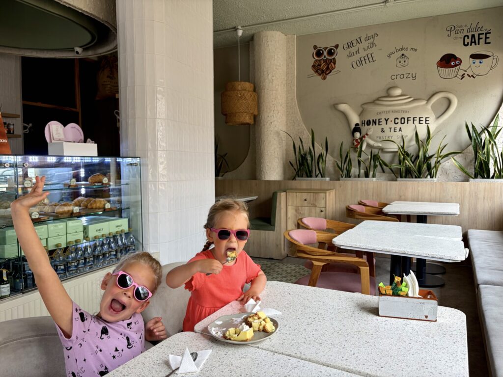 two girls at a coffee shop eating pie