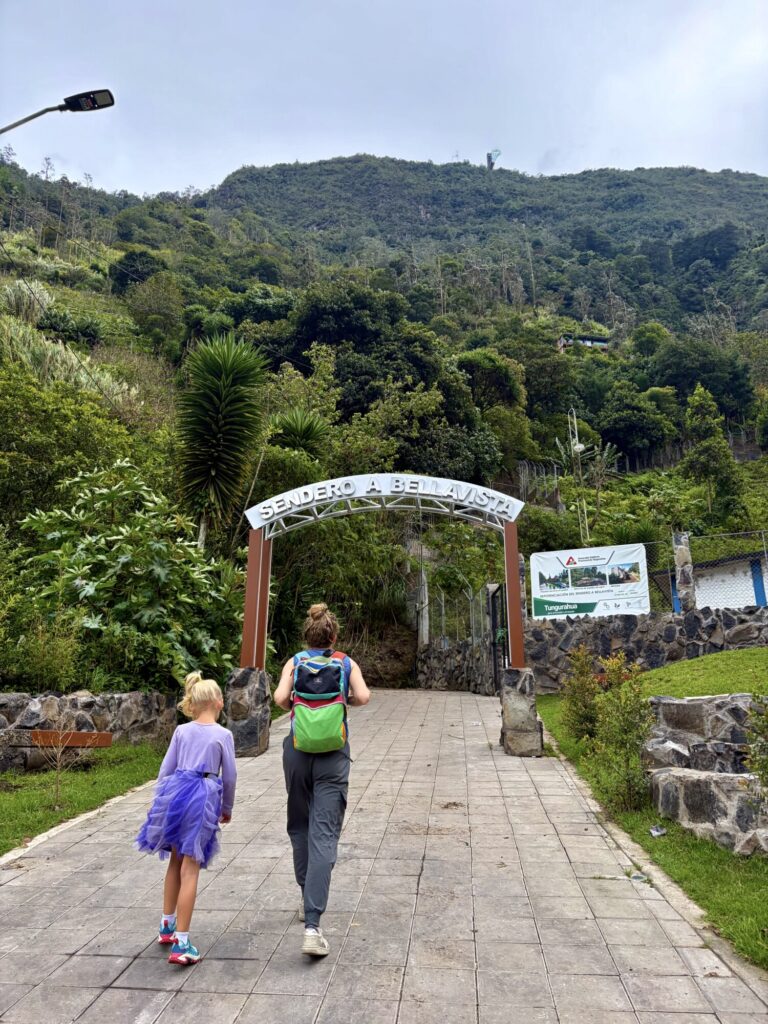a girl and a mother walking up a path to a hike